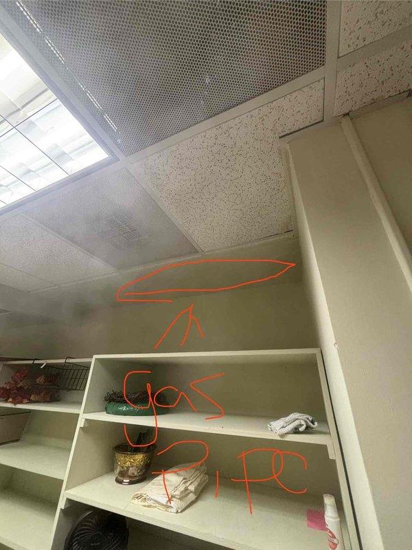 Responded to emergency gas leak call at residential property. Upon arrival, conducted thorough inspection of gas system and identified leak location near HVAC equipment in utility closet. Marked gas line routing through walls and ceiling for reference and documentation. Assessed mechanical room configuration, noting gas piping connections to furnace unit. Photographed affected areas showing gas line pathways and HVAC equipment for service records. Customer also reported clogged floor drain requiring future attention. Initial gas leak assessment and documentation completed as first stop service call.