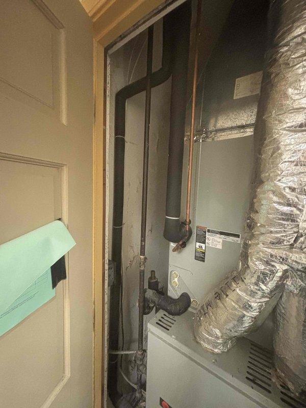 Responded to emergency gas leak call at residential property. Upon arrival, conducted thorough inspection of gas system and identified leak location near HVAC equipment in utility closet. Marked gas line routing through walls and ceiling for reference and documentation. Assessed mechanical room configuration, noting gas piping connections to furnace unit. Photographed affected areas showing gas line pathways and HVAC equipment for service records. Customer also reported clogged floor drain requiring future attention. Initial gas leak assessment and documentation completed as first stop service call.