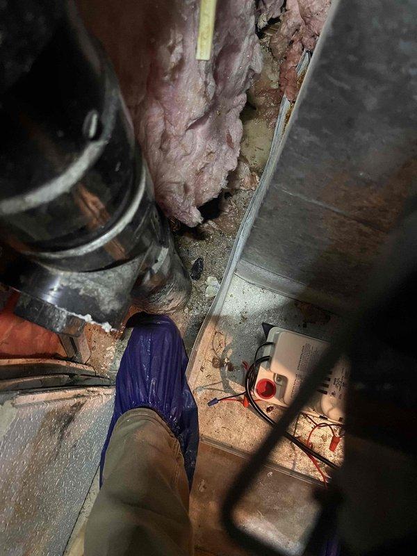 Responded to service call for clogged condensate line in basement mechanical area. Upon inspection, located condensate drain system near air handler with visible blockage preventing proper drainage. Cleared obstruction from PVC condensate line using appropriate tools and techniques. Verified water flow through drain line and confirmed system was draining freely. Tested air handler operation to ensure condensate removal system functioning properly. System restored to normal operation with no further drainage issues observed.