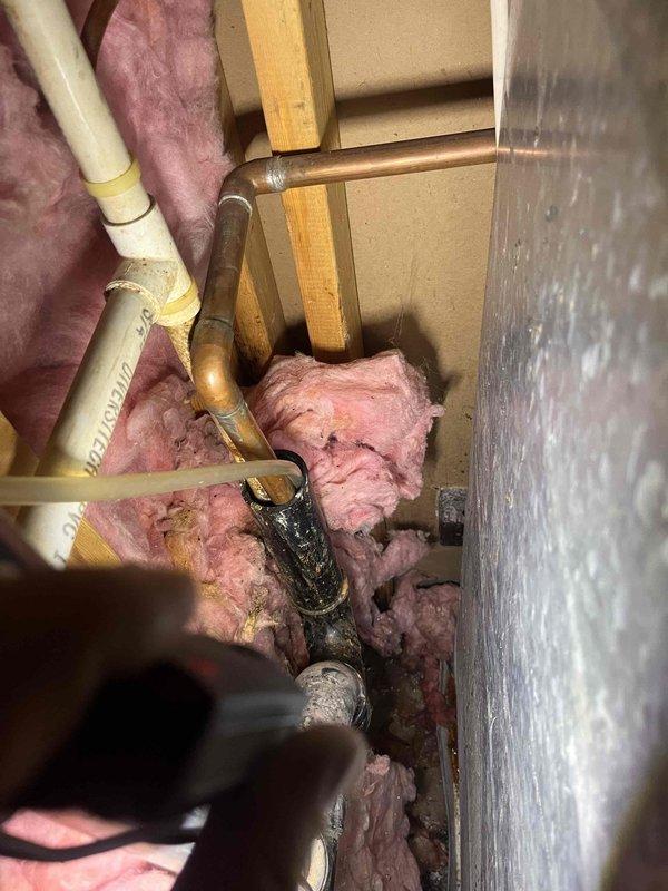 Responded to service call for clogged condensate line in basement mechanical area. Upon inspection, located condensate drain system near air handler with visible blockage preventing proper drainage. Cleared obstruction from PVC condensate line using appropriate tools and techniques. Verified water flow through drain line and confirmed system was draining freely. Tested air handler operation to ensure condensate removal system functioning properly. System restored to normal operation with no further drainage issues observed.