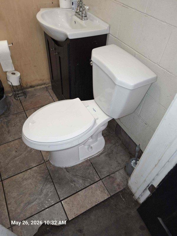Responded to clogged toilet in office bathroom. Removed and reset toilet to access and clear obstruction in drain line. Pulled toilet, removed old wax ring, cleaned toilet flange, and cleared blockage. Installed new wax ring, reinstalled toilet with proper sealing, reconnected water supply line, and tested for proper flush operation and drainage. Verified no leaks at base or supply connection upon completion.