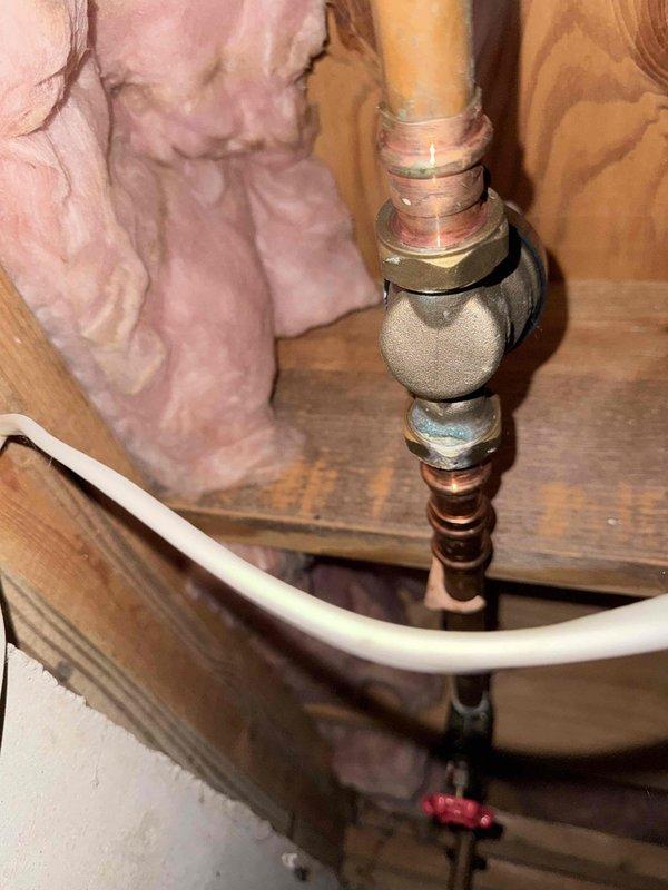 Performed proactive inspection of pressure reducing valve (PRV) in basement as requested by customer. Inspected PRV assembly including copper supply piping, compression fittings, and shut-off valve for proper operation and signs of wear. Verified system pressure reading at gauge showing approximately 50 psi, which is within normal operating range for residential water systems. Examined copper piping for corrosion, oxidation, and structural integrity. Inspected all connections and fittings for leaks or moisture accumulation. Documented existing condition of plumbing components with photographs. PRV found to be functioning properly with no immediate issues or repairs required at this time.