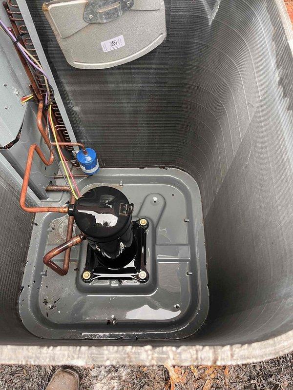 Responded to no cooling complaint for upstairs unit. Upon arrival, discovered condensing unit compressor compartment heavily obstructed with accumulated organic debris including dried leaves and plant material. Removed debris buildup from around compressor and internal components. Inspected refrigerant lines, service ports, and electrical connections for damage. Cleared obstruction to restore proper airflow and component operation. Unit operational following debris removal and system verification.