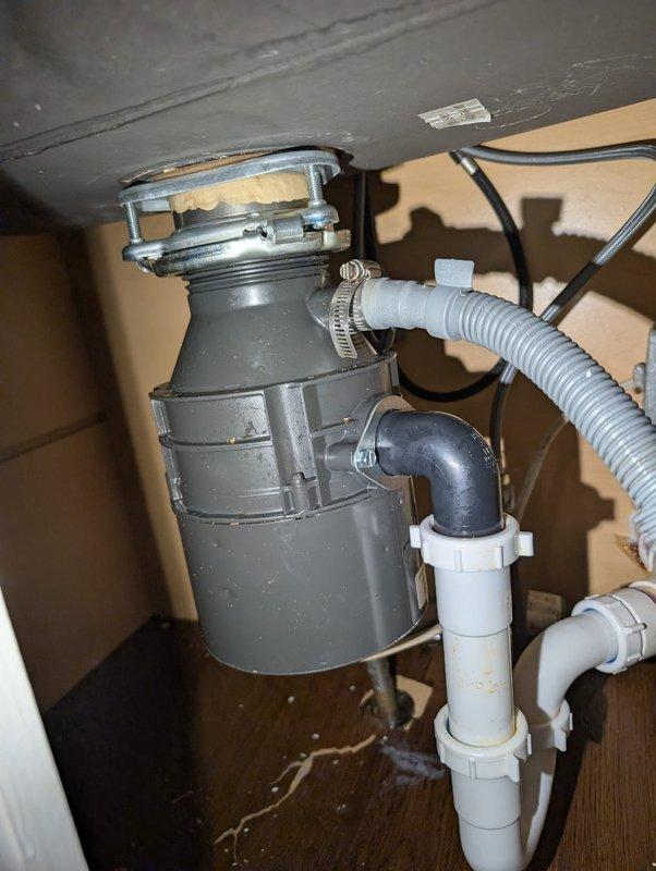 Responded to service call for detached garbage disposal unit. Upon arrival, found disposal had separated from sink mounting assembly. Reinstalled garbage disposal, securing mounting flange and ensuring proper connection to drain line. Verified disposal operation and checked for leaks. Also inspected water heater system pressure, confirming gauge readings within normal operating range.