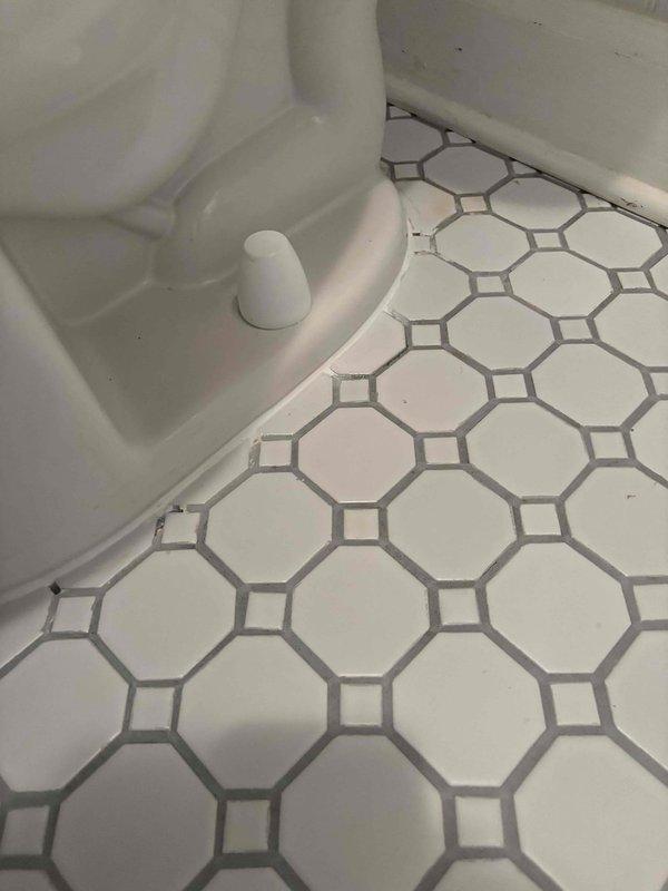 Responded to follow-up service call for reported toilet leak occurring after previous toilet removal and reinstallation during sewer scope procedure. Upon arrival, conducted thorough visual inspection of toilet installation, water supply connections, and surrounding floor area. Examined the flexible braided supply line connection from shut-off valve to tank inlet for proper seating and potential leakage points. Inspected wax ring seal and toilet base-to-floor connection for signs of water seepage. Verified all mounting bolts and hardware were properly secured following the previous reset. Documented conditions of white hexagonal tile flooring, beadboard wainscoting, and fixture connections with photographic evidence. No active leak observed during inspection visit.