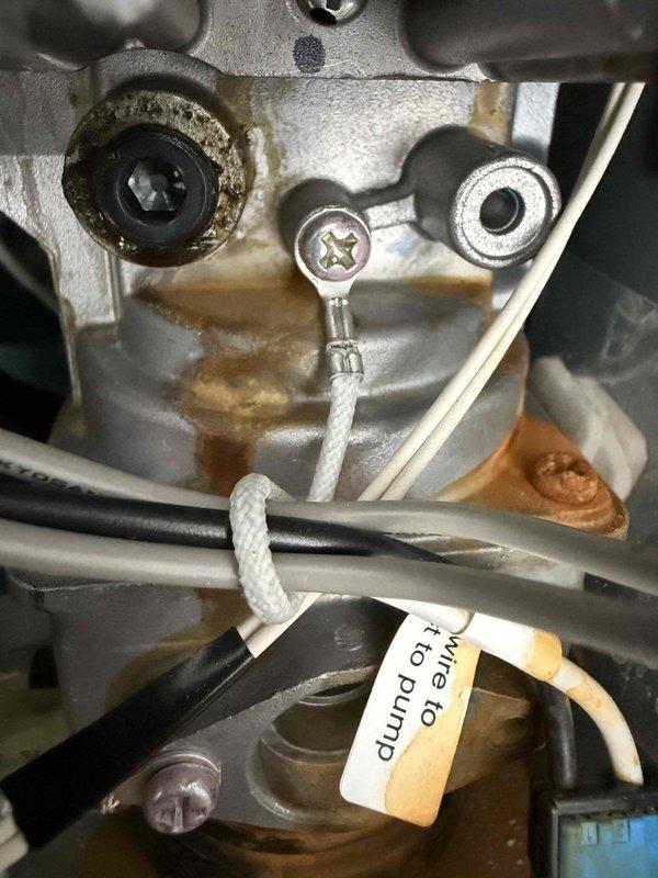 Responded to service call for tankless water heater displaying error code 12, indicating a flame failure issue. Upon arrival, confirmed unit had no prior service history with our company. Performed comprehensive tankless water heater flush procedure to address potential scale buildup and combustion problems. Inspected internal components including pump wiring connections, electrical junction points, and wire harnesses for proper installation and signs of wear. Documented existing component conditions showing minor operational residue and normal wear patterns on mounting brackets and connection points. Verified all electrical connections were secure and properly seated within housing assemblies. Unit operational following flush service; error code cleared after maintenance completion.