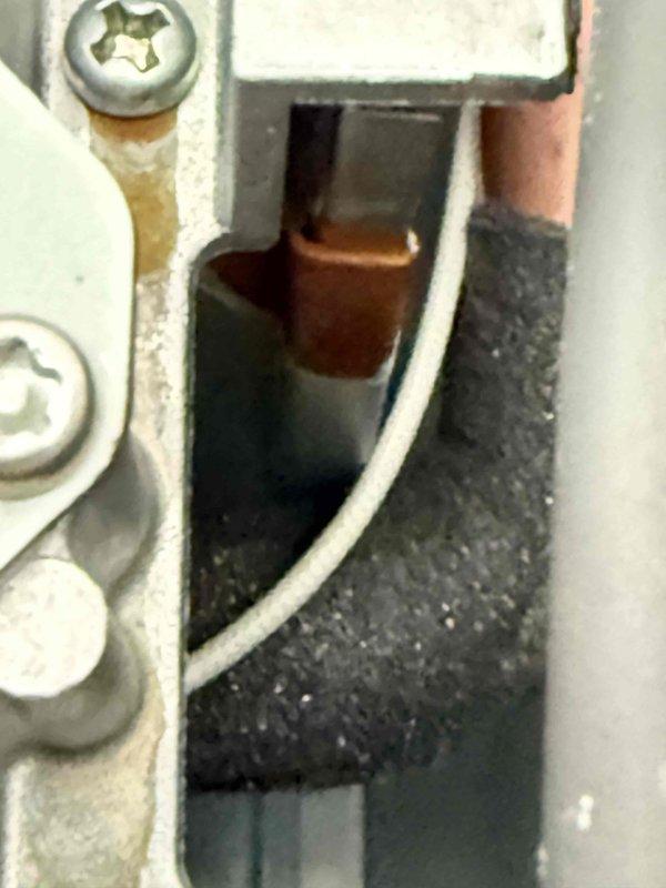 Responded to service call for tankless water heater displaying error code 12, indicating a flame failure issue. Upon arrival, confirmed unit had no prior service history with our company. Performed comprehensive tankless water heater flush procedure to address potential scale buildup and combustion problems. Inspected internal components including pump wiring connections, electrical junction points, and wire harnesses for proper installation and signs of wear. Documented existing component conditions showing minor operational residue and normal wear patterns on mounting brackets and connection points. Verified all electrical connections were secure and properly seated within housing assemblies. Unit operational following flush service; error code cleared after maintenance completion.