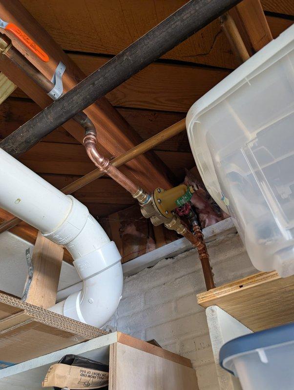Completed water service replacement as specified in approved quote. Installed new copper piping with brass valve assembly featuring dual shut-off controls in crawl space area. Replaced existing water service line infrastructure, including proper integration with white PVC drainage system and installation of white cylindrical expansion tank suspended by copper piping. Connected new service to existing blue PEX distribution lines and secured all components to structural framing using appropriate metal straps and brackets. System tested and confirmed operational with all connections properly sealed and no leaks detected.
