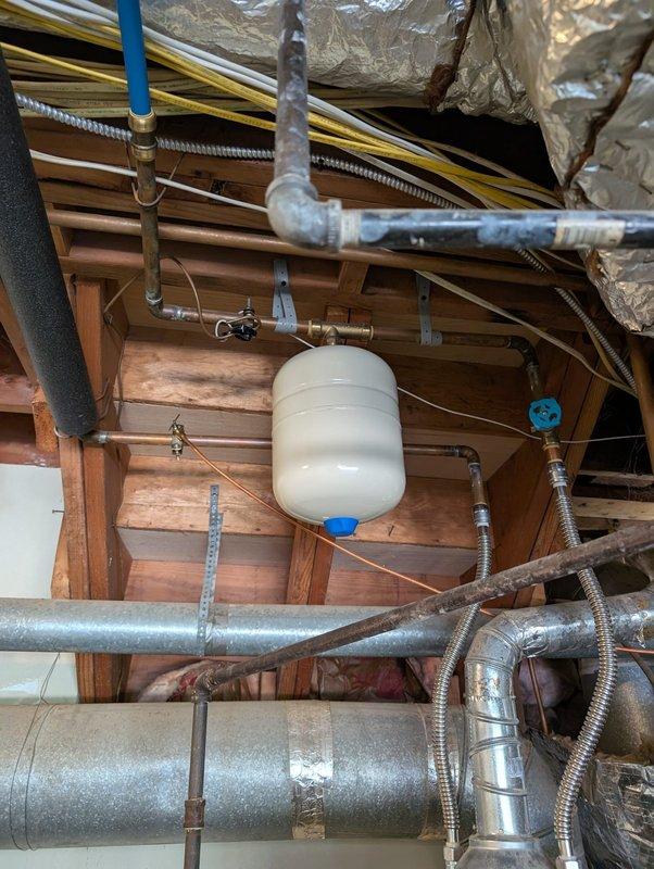 Completed water service replacement as specified in approved quote. Installed new copper piping with brass valve assembly featuring dual shut-off controls in crawl space area. Replaced existing water service line infrastructure, including proper integration with white PVC drainage system and installation of white cylindrical expansion tank suspended by copper piping. Connected new service to existing blue PEX distribution lines and secured all components to structural framing using appropriate metal straps and brackets. System tested and confirmed operational with all connections properly sealed and no leaks detected.