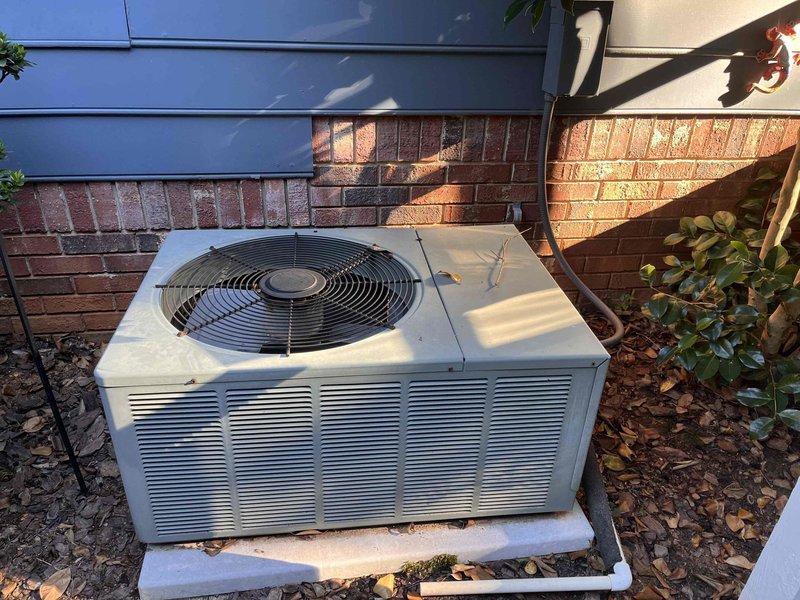 Provided second opinion evaluation of existing HVAC system. Inspected outdoor condenser unit positioned on concrete pad against exterior brick wall, noting older model equipment with visible weathering and age-related wear on cabinet surfaces. Assessed unit's physical condition, mounting location, and clearance requirements for proper airflow. Examined electrical service panel, documenting circuit breaker configuration including multiple 15, 20, 30, and 35 amp breakers serving various building circuits. Photographed equipment and electrical components for documentation purposes. Reviewed system specifications and provided professional assessment to homeowner as requested alternative evaluation.