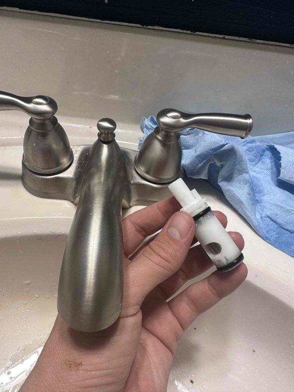 Responded to customer report of slow drip from bathroom faucet. Disassembled two-handle faucet assembly and inspected internal components. Replaced worn cartridge valve with damaged rubber seals that was causing the leak, reassembled faucet, and verified proper operation with no further dripping.