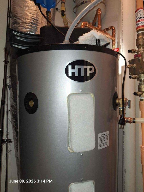 Responded to follow-up service call for ongoing hot water issue. Inspected HTP brand water heater and documented current system configuration including plumbing connections, copper piping network, and pressure relief components. Examined thermostat control unit (WH9C model) and verified temperature settings at 140°F, noting condition of internal wiring and sensor probe. Photographed equipment for comparison with previous service history to identify recurring problem patterns.