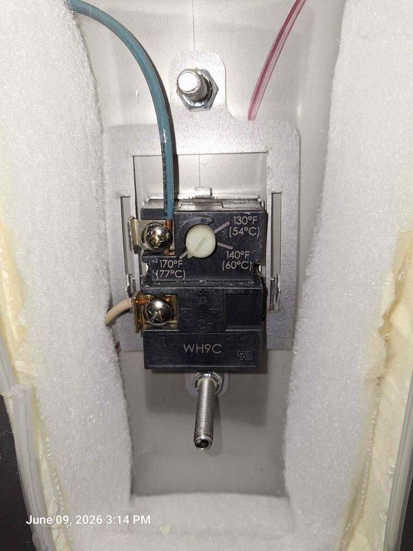 Responded to follow-up service call for ongoing hot water issue. Inspected HTP brand water heater and documented current system configuration including plumbing connections, copper piping network, and pressure relief components. Examined thermostat control unit (WH9C model) and verified temperature settings at 140°F, noting condition of internal wiring and sensor probe. Photographed equipment for comparison with previous service history to identify recurring problem patterns.