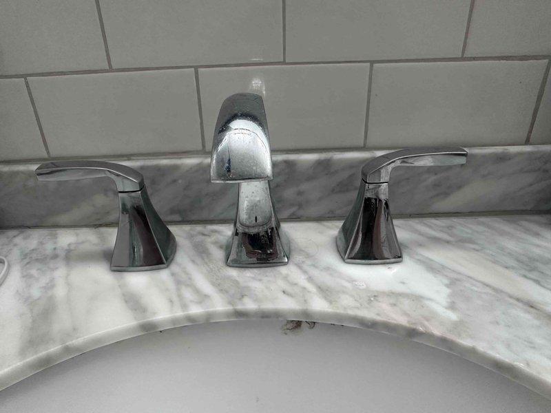 Responded to reported leak from sink and stiff handle on secondary fixture. Upon inspection, identified source of leak at primary sink faucet assembly. Tightened supply line connections and tested both fixtures under full water pressure. Lubricated stiff handle mechanism on secondary sink to restore smooth operation. Verified all connections were secure with no active leaks and confirmed proper drainage on both fixtures.