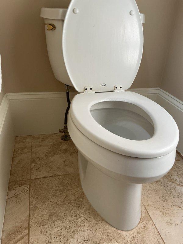 Installed customer-supplied toilet in bathroom corner, connecting water supply line and ensuring proper seal at floor flange. Completed installation with all plumbing connections secured and fixture tested for proper operation and leak-free performance.