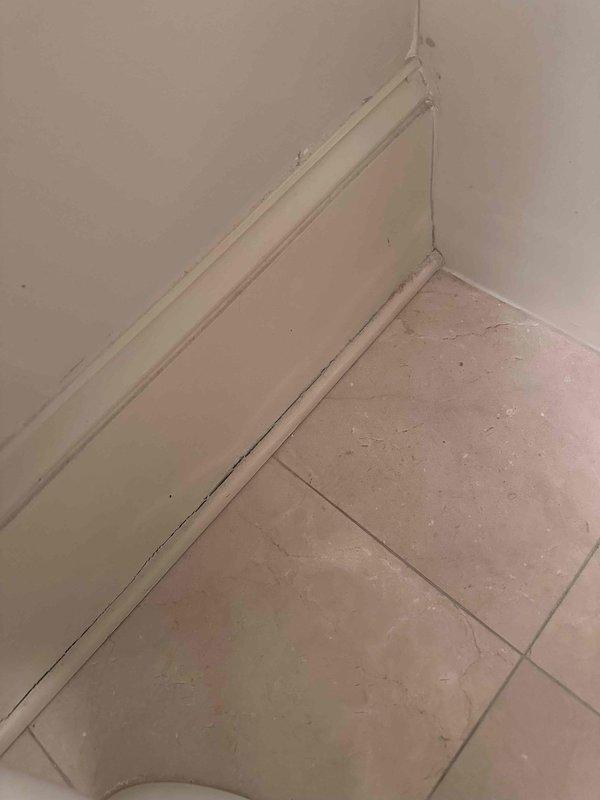 Responded to customer report of small leak at toilet shut-off valve. Upon inspection, identified leak originating from the chrome-plated angle stop valve connection point at the wall supply line. Evaluated braided stainless steel flexible supply line and threaded connections at both the tank inlet and shut-off valve. Tightened compression fittings at the valve to eliminate leak. Verified all connections were secure and tested system by cycling water supply on and off multiple times. Confirmed no active leaking present after repair and ensured proper water flow to toilet tank.