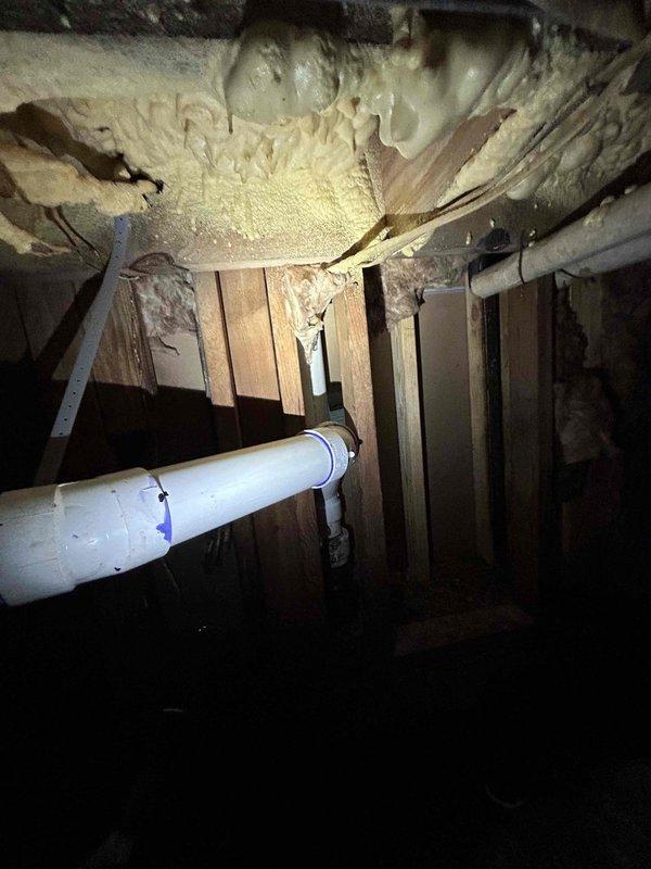 Completed cast iron plumbing rework in crawl space area beneath structure. Removed deteriorated cast iron piping and installed new PVC drainage system with proper venting. Capped all unused openings to prevent sewer gas infiltration and ensure code compliance. All connections were secured and tested for proper drainage flow.