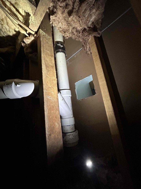 Completed cast iron plumbing rework in crawl space area beneath structure. Removed deteriorated cast iron piping and installed new PVC drainage system with proper venting. Capped all unused openings to prevent sewer gas infiltration and ensure code compliance. All connections were secured and tested for proper drainage flow.