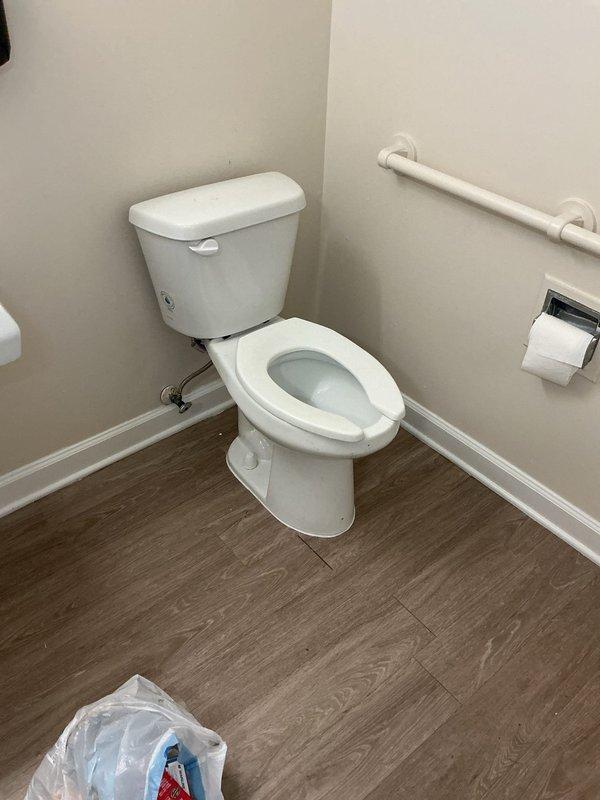 Responded to toilet flange repair request in apartment unit. Upon inspection, found cracked toilet flange with visible water damage and staining on surrounding flooring. Removed existing toilet, replaced damaged flange with new PVC flange, and reinstalled toilet with new wax ring and hardware to ensure proper seal and prevent future leaks.