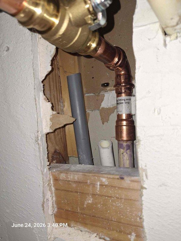 Replaced faulty thermal expansion tank and 3/4" valve on water heater system. Installed new pressure gauge and verified proper system pressure readings within safe operating range. Completed all copper pipe connections and secured fixtures through wall opening, ensuring leak-free operation and code-compliant installation.