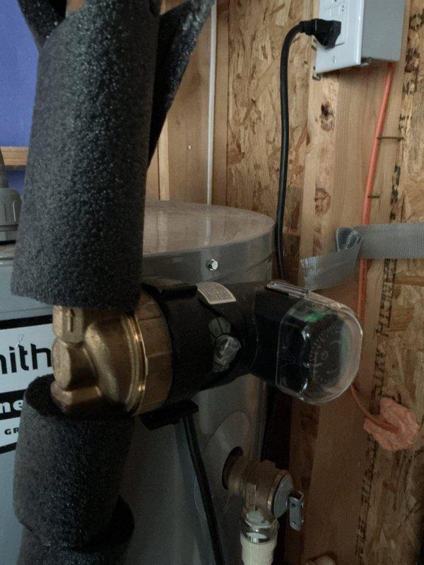Responded to complaint of buzzing noise from recirculation pump. Upon inspection, identified excessive vibration from pump mounted on exposed plumbing system. Insulated copper piping with foam pipe insulation to reduce noise transmission through building structure. Verified system pressure using calibrated gauge, confirming operating pressure within normal parameters. Pump operation restored to quiet functioning condition with no further abnormal sounds detected during testing.