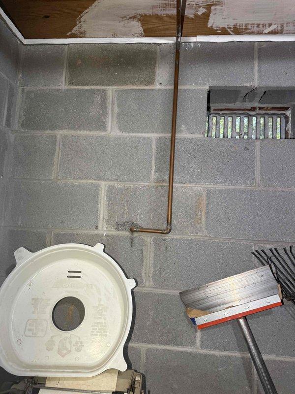 Responded to customer report of leaking hose bib on exterior brick wall. Upon inspection, identified leak at outdoor water spigot connection point where garden hose coupling attached to the fixture. Accessed interior side of hose bib through basement utility area, locating copper supply line running vertically along concrete block wall. Replaced faulty hose bib assembly and verified proper seal at all connection points. Tested system for leaks and confirmed repair resolved the issue with no further water discharge observed at exterior or interior locations.