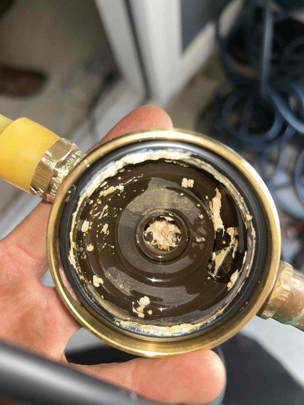 Replaced water heater and associated plumbing connections in mechanical room. Installed new white cylindrical water heater with proper pipe insulation on copper supply lines. Connected flexible metallic tubing and integrated unit with existing blue pressure tank system. Cleaned and serviced brass valve component that showed significant internal sediment buildup and deposits. Verified all connections for proper operation and system integrity.