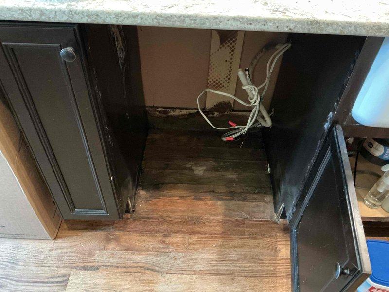 Responded to service call for dishwasher water line connection and slow-draining bathtub. Upon inspection, discovered severely corroded and deteriorated flexible shower hose in bathtub with extensive mineral buildup and corrosion requiring replacement. Assessed kitchen area where dishwasher installation was requested, noting exposed electrical wiring with wire connectors in place and cabinetry configuration for appliance hookup. Documented existing plumbing conditions including tub drain assembly and fixtures for necessary repairs to restore proper drainage function.