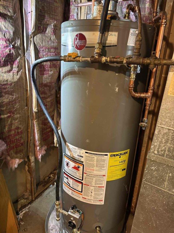 Responded to service call for leaking 50-gallon gas water heater. Upon inspection, determined the existing unit had developed a tank leak and required complete replacement. Removed and properly disposed of the failed water heater in accordance with local regulations.

Installed new Rheem Professional Series 50-gallon gas water heater as replacement. Configured all necessary plumbing connections using copper piping with brass fittings and shut-off valves for both hot and cold water lines. Connected gas supply line with appropriate shut-off valve for safety and code compliance. Installed thermal expansion tank at the top of the unit to protect against excessive pressure buildup in the closed water system.

Verified all connections for proper seal and tested for gas leaks using approved detection methods. Filled tank, purged air from lines, and fired unit to confirm proper ignition and burner operation. Checked temperature and pressure relief valve for proper function. Ensured all safety 