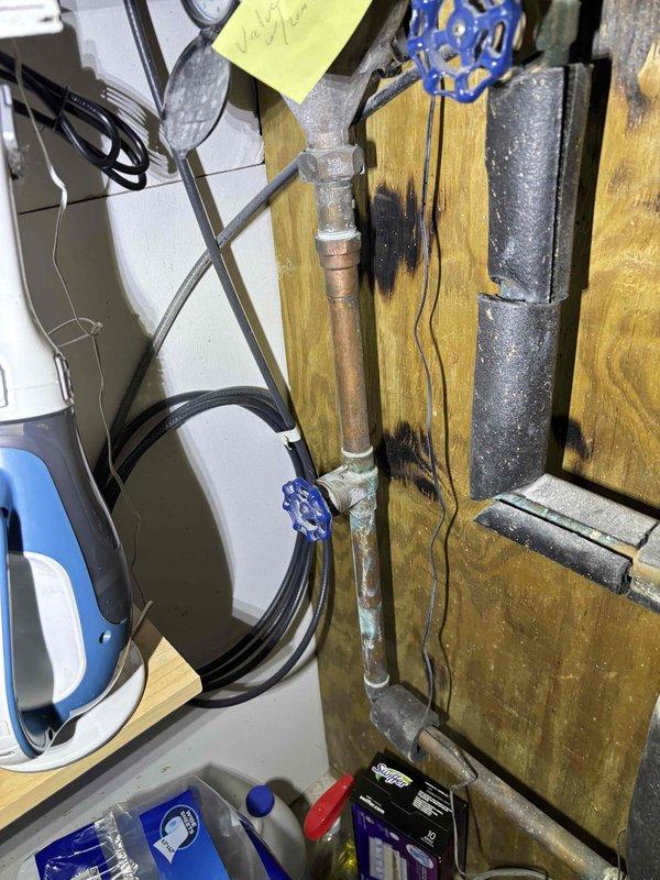 Responded to leak on 1-inch copper water line in basement utility area. Upon arrival, inspected the piping system which included a network of copper and galvanized pipes with multiple valves, fittings, and connection points showing signs of age and oxidation. Located the source of the leak at a compromised section of the copper line. Shut off water supply using existing gate valves to isolate the affected section. Removed the damaged portion of copper pipe and prepared pipe ends for repair. Installed new copper pipe section using proper fittings and connections. Soldered joints to ensure watertight seal. Restored water supply and pressure tested the repair to verify no leaks present. Confirmed all connections were secure and system was functioning properly before completing the service call.
