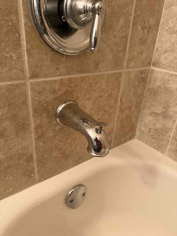 Responded to service call for multiple plumbing issues throughout the residence. Addressed slow-draining basement bathroom sink by clearing obstruction from drain line. Inspected master bathroom trap and identified improper leveling causing drainage concerns. 

In separate bathroom, diagnosed malfunctioning tub/shower diverter that was failing to redirect water flow to shower head. Found diverter mechanism loose and not engaging properly. Removed existing diverter spout and prepared copper stub-out for replacement fixture installation. Photographed exposed copper pipe extending from tiled wall to document condition and verify proper positioning for new diverter assembly.

Performed requested inspection of water heater and confirmed unit operating within normal parameters with no active issues or safety concerns identified at time of service. All affected fixtures and systems evaluated and findings documented with photographic evidence.