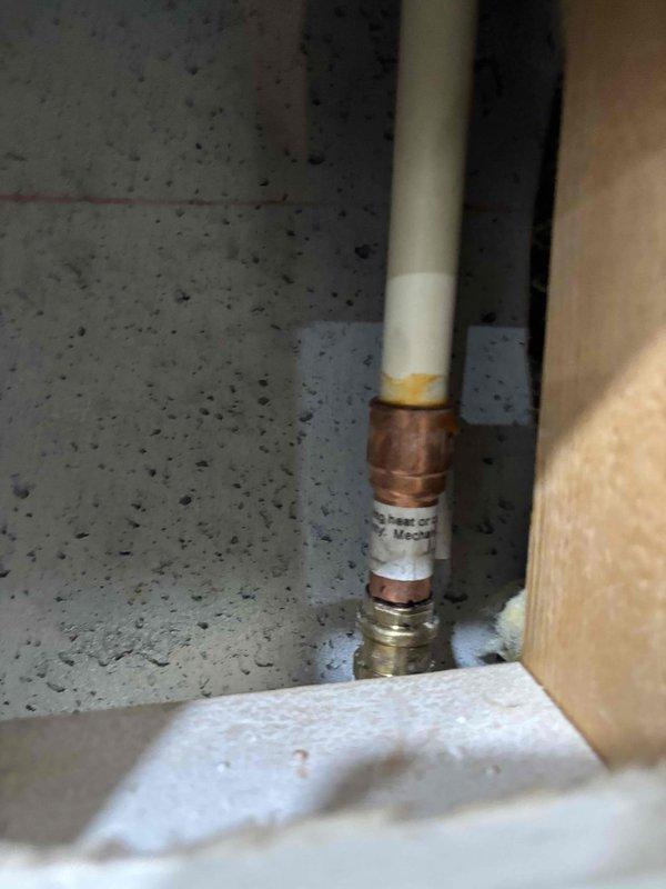 Responded to pressure issue following recent remodel work. Inspected plumbing installation in basement/utility area, documenting vertical PVC riser with copper fittings and compression couplings, as well as CPVC pipe connections with elbow joints. Previous contractor's work required evaluation to identify source of pressure problems affecting the system.