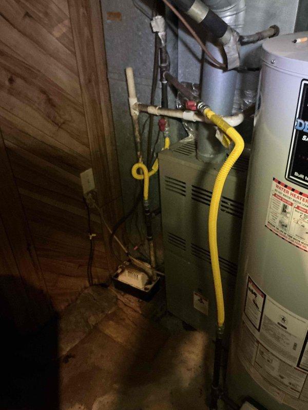Responded to service call for dual-system HVAC concern regarding outdoor unit operation. Performed diagnostic evaluation of both systems, including inspection of indoor furnace equipment and outdoor condensing units. Tested electrical components including capacitors and contactor operation on outdoor unit using multimeter. Verified gas line connections, ductwork configuration, and overall system functionality. Unable to complete full diagnostic due to lack of thermostat control at time of service visit.