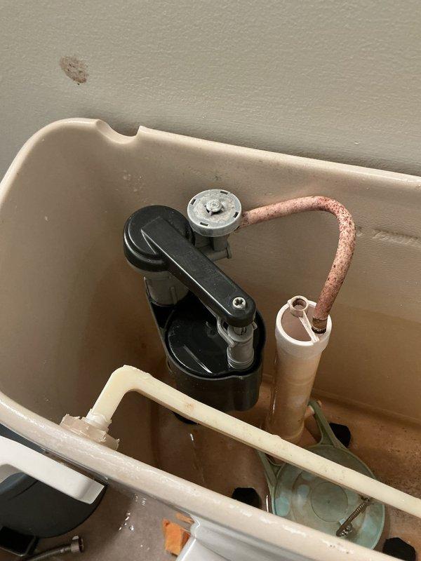 Responded to follow-up service call for toilet not flushing or filling properly. Upon inspection, documented the condition of the toilet tank components including the flush valve assembly, fill valve mechanism, flapper chain, and overflow tube. Tank interior showed significant water discoloration and mineral deposits indicating potential water quality issues or component deterioration that may be affecting proper flushing and filling operation. Responded to follow-up service call for toilet not flushing or filling properly. Upon inspection, documented the condition of the toilet tank components including the flush valve assembly, fill valve mechanism, flapper chain, and overflow tube. Tank interior showed significant water discoloration and mineral deposits indicating potential water quality issues or component deterioration that may be affecting proper flushing and filling operation.