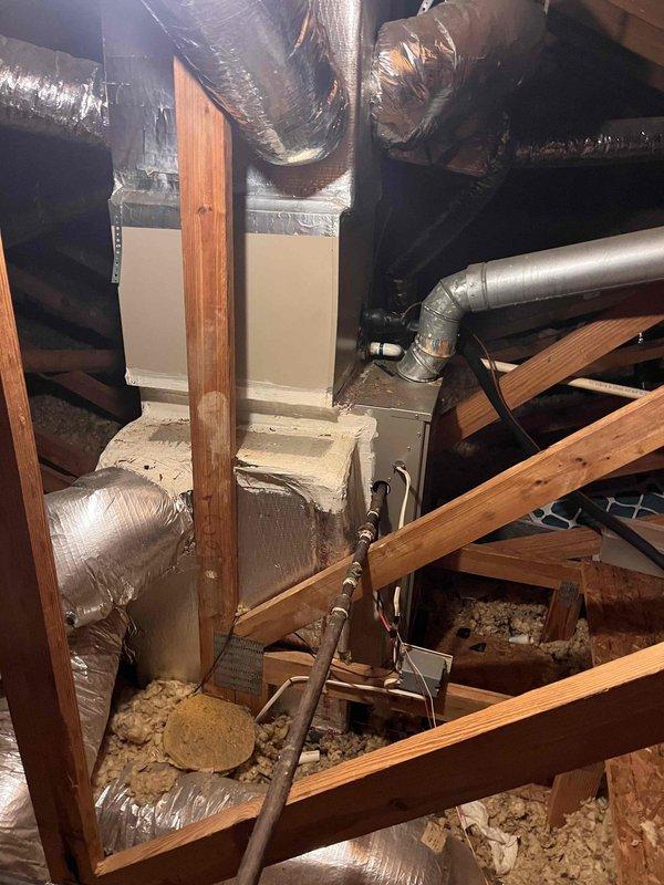 Responded to no cooling call for dual-zone residential HVAC system with basement and upstairs units. Upon arrival, confirmed both systems were non-operational. Customer reported basement unit was the original problem, which was resolved after resetting a tripped breaker, but the secondary upstairs unit subsequently stopped working. Inspected upstairs air handler and associated ductwork in attic space. Examined flexible duct connections, metallic insulation integrity, and equipment mounting. Verified all electrical connections, checked refrigerant lines, and assessed overall system operation. Both units restored to proper cooling function.