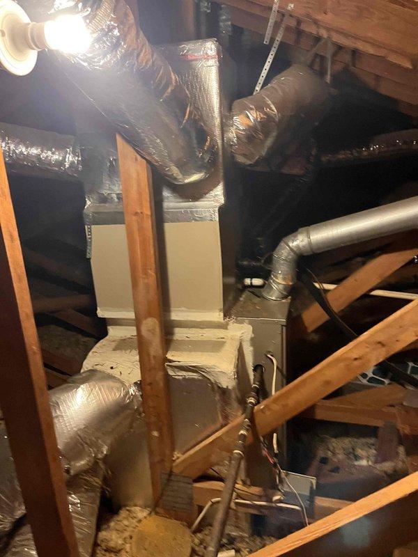 Responded to no cooling call for dual-zone residential HVAC system with basement and upstairs units. Upon arrival, confirmed both systems were non-operational. Customer reported basement unit was the original problem, which was resolved after resetting a tripped breaker, but the secondary upstairs unit subsequently stopped working. Inspected upstairs air handler and associated ductwork in attic space. Examined flexible duct connections, metallic insulation integrity, and equipment mounting. Verified all electrical connections, checked refrigerant lines, and assessed overall system operation. Both units restored to proper cooling function.