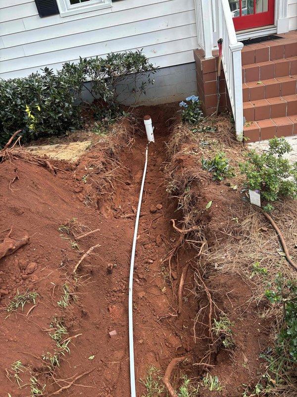Completed full sewer line replacement at residential property. Excavated trench approximately 3-4 feet deep through lawn and landscaping beds, running parallel to house foundation through red clay soil. Removed existing deteriorated sewer line and installed new white PVC pipe from house connection to main sewer system. Installation included proper cleanout access point at base of trench for future maintenance needs. Backfilled excavated area upon completion of pipe installation and pressure testing. All work performed met local plumbing codes and specifications outlined in approved quote. Completed full sewer line replacement at residential property. Excavated trench approximately 3-4 feet deep through lawn and landscaping beds, running parallel to house foundation through red clay soil. Removed existing deteriorated sewer line and installed new white PVC pipe from house connection to main sewer system. Installation included proper cleanout access point at base of trench for future maintenance needs. Backfilled excavated area upon completion of pipe installation and pressure testing. All work performed met local plumbing codes and specifications outlined in approved quote.