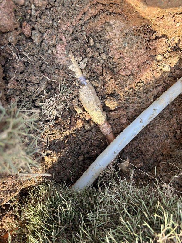 Completed water service line replacement from main to structure. Excavated and removed deteriorated existing service line, installed new water service piping with proper bedding and backfill. Connected new service line to existing plumbing infrastructure in mechanical room where dual water heaters are located. Verified all connections, tested system for proper operation and pressure, restored excavated area. Documentation photos captured of excavation work and mechanical room plumbing configuration.
