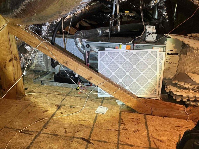 Conducted comprehensive HVAC system assessment in attic space for new homeowner seeking equipment upgrade estimates. Inspected existing air handler unit, ductwork configuration, and condensate drainage system. Documented current system conditions including metal drain pan showing rust staining and water discoloration indicative of moisture accumulation, reflective insulated ductwork with visible material separation, black condensate pump component, and air handler with pleated filter. Noted flexible black ductwork runs, metallic supply ducting, and pink fiberglass insulation between rafters. Provided detailed photographic documentation of all equipment and components for future replacement planning. Conducted comprehensive HVAC system assessment in attic space for new homeowner seeking equipment upgrade estimates. Inspected existing air handler unit, ductwork configuration, and condensate drainage system. Documented current system conditions including metal drain pan showing rust staining and water discoloration indicative of moisture accumulation, reflective insulated ductwork with visible material separation, black condensate pump component, and air handler with pleated filter. Noted flexible black ductwork runs, metallic supply ducting, and pink fiberglass insulation between rafters. Provided detailed photographic documentation of all equipment and components for future replacement planning.