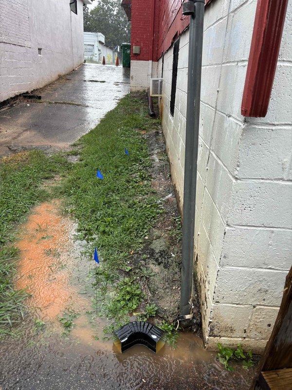 Responded to water intrusion complaint in basement. Upon investigation, identified active water infiltration from exterior foundation area entering crawl space. Inspected plumbing system including supply lines, shut-off valves, and drain components - no active leaks detected from interior plumbing. Traced water source to exterior drainage issue along building foundation where standing water and inadequate grading were directing surface runoff toward structure. Marked utility locations and documented compromised drainage patterns in alleyway adjacent to foundation. Water staining observed on crawl space ceiling materials consistent with moisture penetration from exterior source rather than plumbing failure. Responded to water intrusion complaint in basement. Upon investigation, identified active water infiltration from exterior foundation area entering crawl space. Inspected plumbing system including supply lines, shut-off valves, and drain components - no active leaks detected from interior plumbing. Traced water source to exterior drainage issue along building foundation where standing water and inadequate grading were directing surface runoff toward structure. Marked utility locations and documented compromised drainage patterns in alleyway adjacent to foundation. Water staining observed on crawl space ceiling materials consistent with moisture penetration from exterior source rather than plumbing failure.