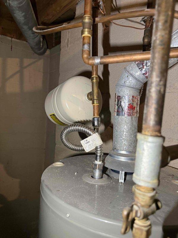 Responded to service call regarding multiple plumbing and gas concerns at residential property. Conducted comprehensive inspection of water heater system, thermal expansion tank piping, and garage gas line. Evaluated existing expansion tank configuration and identified bent piping requiring replacement recommendation. Inspected copper piping connections, brass fittings, and PVC drainage system for proper operation. Assessed hot water temperature settings and pressure relief components for safety compliance. Performed gas leak detection testing on garage gas line to verify system integrity and rule out potential hazards. Examined backup water pressure line for functionality issues. Documented current plumbing configuration with photographs showing water heater assembly, expansion tanks, copper supply lines, and drainage piping. Provided customer with detailed estimate for necessary piping replacement and system adjustments to address identified concerns. Responded to service call regarding multiple plumbing and gas concerns at residential property. Conducted comprehensive inspection of water heater system, thermal expansion tank piping, and garage gas line. Evaluated existing expansion tank configuration and identified bent piping requiring replacement recommendation. Inspected copper piping connections, brass fittings, and PVC drainage system for proper operation. Assessed hot water temperature settings and pressure relief components for safety compliance. Performed gas leak detection testing on garage gas line to verify system integrity and rule out potential hazards. Examined backup water pressure line for functionality issues. Documented current plumbing configuration with photographs showing water heater assembly, expansion tanks, copper supply lines, and drainage piping. Provided customer with detailed estimate for necessary piping replacement and system adjustments to address identified concerns.