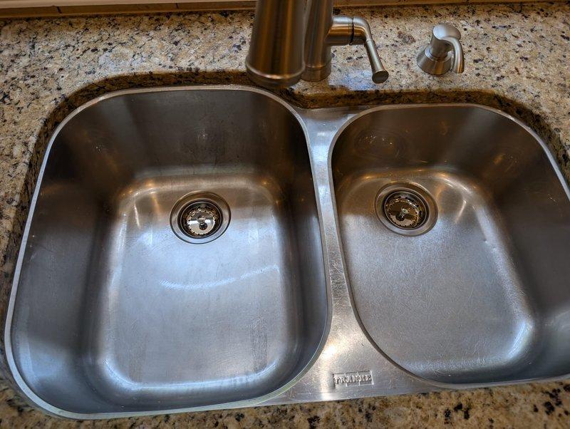 Responded to service call for clogged garbage disposal and kitchen faucet issues. Upon assessment, successfully cleared the disposal blockage and installed a new kitchen faucet with pull-out spray head attachment and matching soap dispenser. Rather than replacing the entire sink assembly, performed adjustment and repositioning of the existing double-basin stainless steel sink to ensure proper fit and function within the granite countertop. All components tested and verified operational upon completion. Responded to service call for clogged garbage disposal and kitchen faucet issues. Upon assessment, successfully cleared the disposal blockage and installed a new kitchen faucet with pull-out spray head attachment and matching soap dispenser. Rather than replacing the entire sink assembly, performed adjustment and repositioning of the existing double-basin stainless steel sink to ensure proper fit and function within the granite countertop. All components tested and verified operational upon completion.
