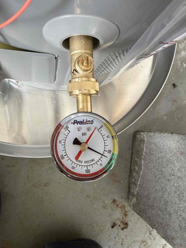 # Water Heater Expansion Tank Replacement and Pressure Regulation
Responded to service call for leaking expansion tank and elevated water pressure on residential water heater system. Upon arrival, performed visual inspection of Rheem water heater and associated plumbing components.
## Issues Identified
Confirmed expansion tank failure with active leak at tank connection point. Pressure gauge reading indicated system pressure exceeding recommended operating range, measuring above safe threshold on ProLine gauge mounted at water heater inlet. Excessive pressure contributing to expansion tank failure and potential risk to water heater integrity.
## Work Performed
- Shut off water supply to water heater system
- Drained and depressurized existing failed expansion tank
- Removed compromised expansion tank from wall-mounted bracket
- Installed new white cylindrical expansion tank with proper sizing for system capacity
- Secured expansion tank to wall using black mounting straps for stab # Water Heater Expansion Tank Replacement and Pressure Regulation
Responded to service call for leaking expansion tank and elevated water pressure on residential water heater system. Upon arrival, performed visual inspection of Rheem water heater and associated plumbing components.
## Issues Identified
Confirmed expansion tank failure with active leak at tank connection point. Pressure gauge reading indicated system pressure exceeding recommended operating range, measuring above safe threshold on ProLine gauge mounted at water heater inlet. Excessive pressure contributing to expansion tank failure and potential risk to water heater integrity.
## Work Performed
- Shut off water supply to water heater system
- Drained and depressurized existing failed expansion tank
- Removed compromised expansion tank from wall-mounted bracket
- Installed new white cylindrical expansion tank with proper sizing for system capacity
- Secured expansion tank to wall using black mounting straps for stab