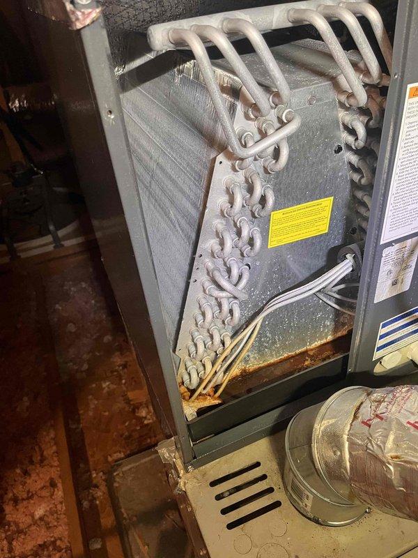 Responded to no cooling complaint on residential HVAC system. Upon inspection, found evaporator coil heavily restricted with dust and debris accumulation, significantly reducing airflow and heat transfer efficiency. Noted visible corrosion and rust in condensate drain pan indicating long-term moisture exposure and lack of routine maintenance. Cleaned evaporator coil thoroughly, removing accumulated contaminants from aluminum fins and copper refrigerant lines. Inspected condensate drainage system and verified proper operation. Checked refrigerant lines and connections for leaks or damage. System airflow restored to normal operating parameters. Advised customer of drain pan corrosion and recommended monitoring for potential replacement to prevent future water damage. Unit tested and confirmed proper cooling operation before departure. Responded to no cooling complaint on residential HVAC system. Upon inspection, found evaporator coil heavily restricted with dust and debris accumulation, significantly reducing airflow and heat transfer efficiency. Noted visible corrosion and rust in condensate drain pan indicating long-term moisture exposure and lack of routine maintenance. Cleaned evaporator coil thoroughly, removing accumulated contaminants from aluminum fins and copper refrigerant lines. Inspected condensate drainage system and verified proper operation. Checked refrigerant lines and connections for leaks or damage. System airflow restored to normal operating parameters. Advised customer of drain pan corrosion and recommended monitoring for potential replacement to prevent future water damage. Unit tested and confirmed proper cooling operation before departure.