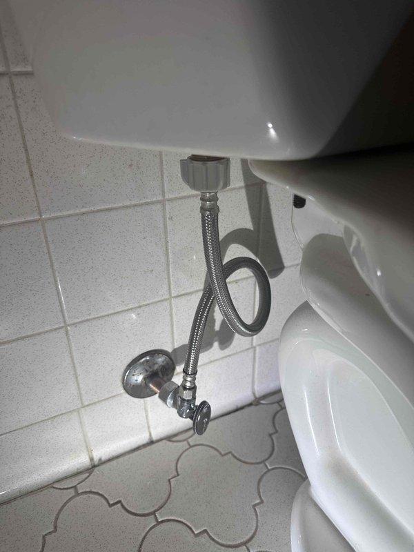 Responded to complaint of upstairs toilet not functioning properly. Upon inspection, found toilet tank with extremely low water level and visible sediment buildup at bottom of tank. Examined flush mechanism components including fill valve assembly with red cap, black cylindrical valve, and overflow tube system. Assessed braided metal supply line and chrome shut-off valve connection from wall to toilet tank, which appeared in good condition. Documented interior tank conditions showing mineral deposits, staining, and discoloration consistent with age and water quality issues affecting proper tank filling and flush operation. Responded to complaint of upstairs toilet not functioning properly. Upon inspection, found toilet tank with extremely low water level and visible sediment buildup at bottom of tank. Examined flush mechanism components including fill valve assembly with red cap, black cylindrical valve, and overflow tube system. Assessed braided metal supply line and chrome shut-off valve connection from wall to toilet tank, which appeared in good condition. Documented interior tank conditions showing mineral deposits, staining, and discoloration consistent with age and water quality issues affecting proper tank filling and flush operation.