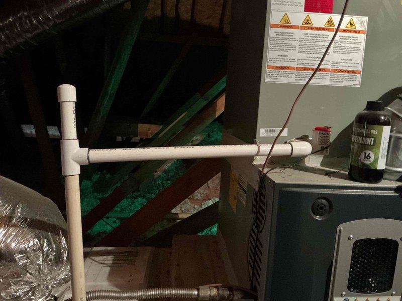 Conducted free estimate for clogged drainage line. Inspected HVAC condensate system in basement utility area and exterior discharge point at building foundation. Documented PVC drainage assembly, condensate collection pan with standing water, and flexible discharge hose configuration to assess blockage location and recommend appropriate clearing solution.