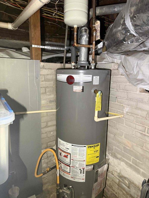 Completed consultation and assessment for conversion from existing gas-fired tank-style water heater to tankless system. Evaluated current installation including gas supply line, venting configuration through attic space, electrical requirements, and existing plumbing connections. Inspected galvanized and copper supply piping, expansion tank, shutoff valves, and available clearances in mechanical room. Assessed gas line capacity, existing flue pipe routing through ceiling joists, and structural considerations for mounting tankless unit. Documented current water heater specifications and mechanical room layout. Provided recommendations for tankless water heater installation including necessary upgrades to gas piping, venting modifications, electrical service requirements, and optimal unit placement for code compliance and efficient operation. Completed consultation and assessment for conversion from existing gas-fired tank-style water heater to tankless system. Evaluated current installation including gas supply line, venting configuration through attic space, electrical requirements, and existing plumbing connections. Inspected galvanized and copper supply piping, expansion tank, shutoff valves, and available clearances in mechanical room. Assessed gas line capacity, existing flue pipe routing through ceiling joists, and structural considerations for mounting tankless unit. Documented current water heater specifications and mechanical room layout. Provided recommendations for tankless water heater installation including necessary upgrades to gas piping, venting modifications, electrical service requirements, and optimal unit placement for code compliance and efficient operation.
