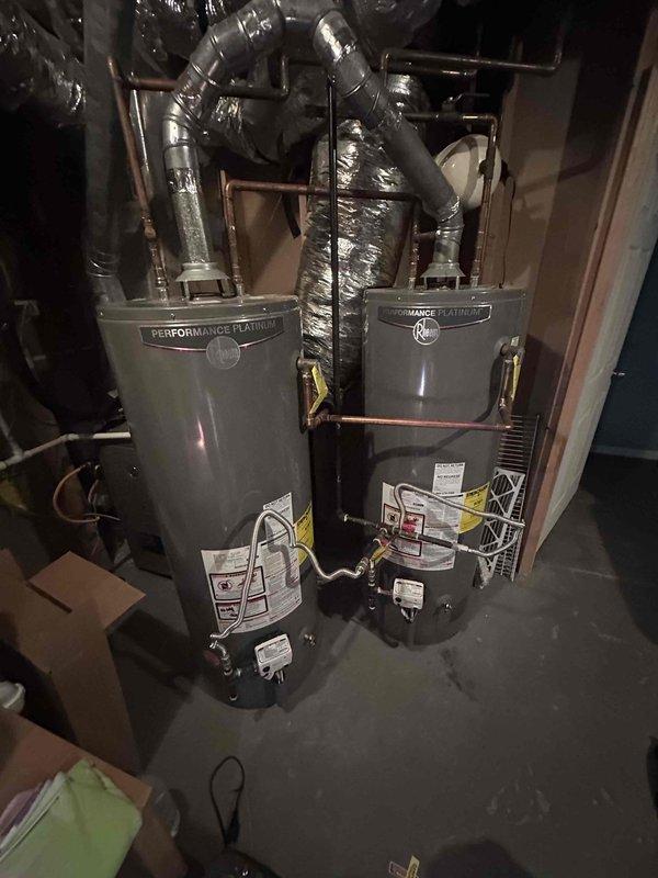 Responded to customer complaint regarding elevated water consumption. Upon inspection of utility room, identified two Performance Platinum water heaters installed in tandem configuration. Conducted thorough visual examination of both units, associated copper piping, flexible ductwork connections, and all visible plumbing fixtures. Inspected water heater valves, fittings, and connections for signs of moisture, corrosion, or active leakage. Documented equipment condition and installation setup with photographs for service records. Responded to customer complaint regarding elevated water consumption. Upon inspection of utility room, identified two Performance Platinum water heaters installed in tandem configuration. Conducted thorough visual examination of both units, associated copper piping, flexible ductwork connections, and all visible plumbing fixtures. Inspected water heater valves, fittings, and connections for signs of moisture, corrosion, or active leakage. Documented equipment condition and installation setup with photographs for service records.