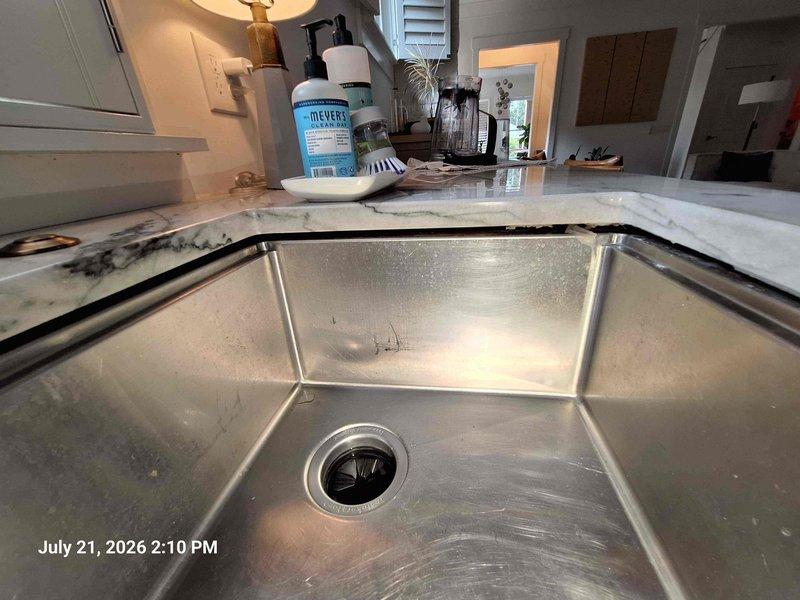 Responded to service call for condensate line backup causing overflow through basement vent cap onto floor. Inspected drainage system in mechanical room, identified blockage in condensate drain line, and cleared obstruction to restore proper drainage flow. Secured loose undermount kitchen sink that had detached from countertop mounting points, ensuring proper support and preventing further separation from granite surface. Responded to service call for condensate line backup causing overflow through basement vent cap onto floor. Inspected drainage system in mechanical room, identified blockage in condensate drain line, and cleared obstruction to restore proper drainage flow. Secured loose undermount kitchen sink that had detached from countertop mounting points, ensuring proper support and preventing further separation from granite surface.