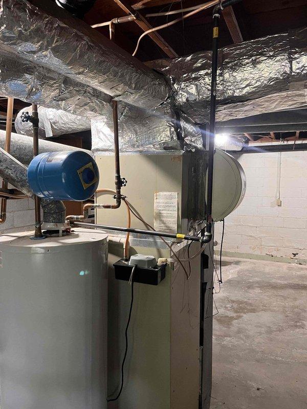 Responded to no cooling call for second opinion evaluation. Upon arrival, performed comprehensive system inspection of existing HVAC equipment located in basement mechanical room. Documented electrical panel configuration showing main disconnect and circuit breaker arrangement. Inspected furnace unit with attached humidifier, water heater with expansion tank, and associated ductwork wrapped in reflective insulation. Photographed equipment conditions and panel markings for customer records. Provided professional assessment of system status and discussed findings with homeowner regarding previously obtained quotes from other contractors. Responded to no cooling call for second opinion evaluation. Upon arrival, performed comprehensive system inspection of existing HVAC equipment located in basement mechanical room. Documented electrical panel configuration showing main disconnect and circuit breaker arrangement. Inspected furnace unit with attached humidifier, water heater with expansion tank, and associated ductwork wrapped in reflective insulation. Photographed equipment conditions and panel markings for customer records. Provided professional assessment of system status and discussed findings with homeowner regarding previously obtained quotes from other contractors.